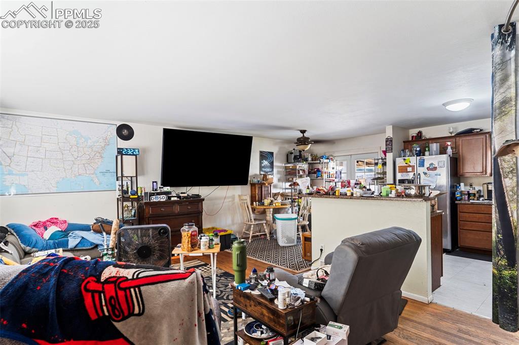 Image 4 of 25: Living area featuring wood finished floors