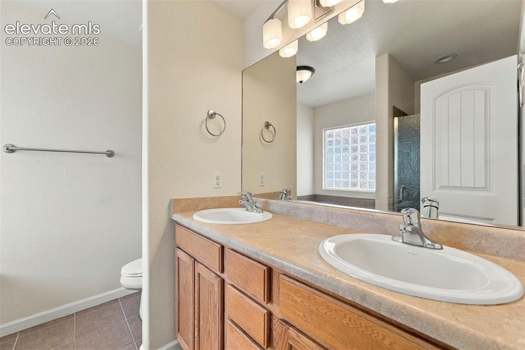 Image 15 of 50: Bathroom vanity featuring dual under-mount sinks, integrated solid-surface 