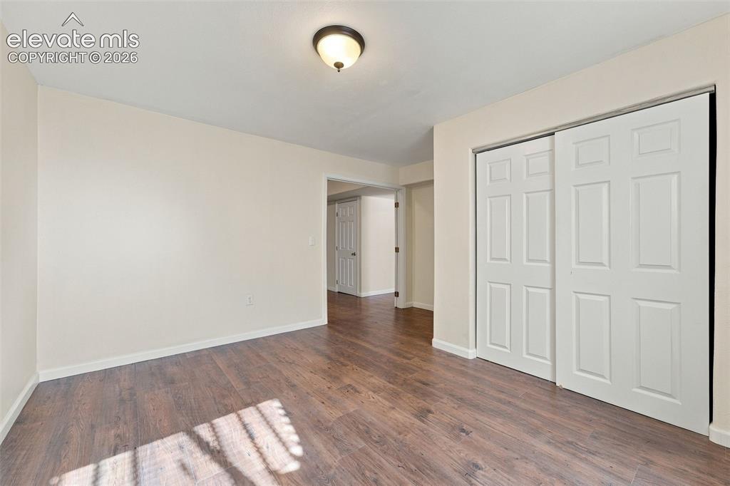Image 29 of 50: Wood-finish flooring, neutral wall tones, semi-flush mount lighting, and a 