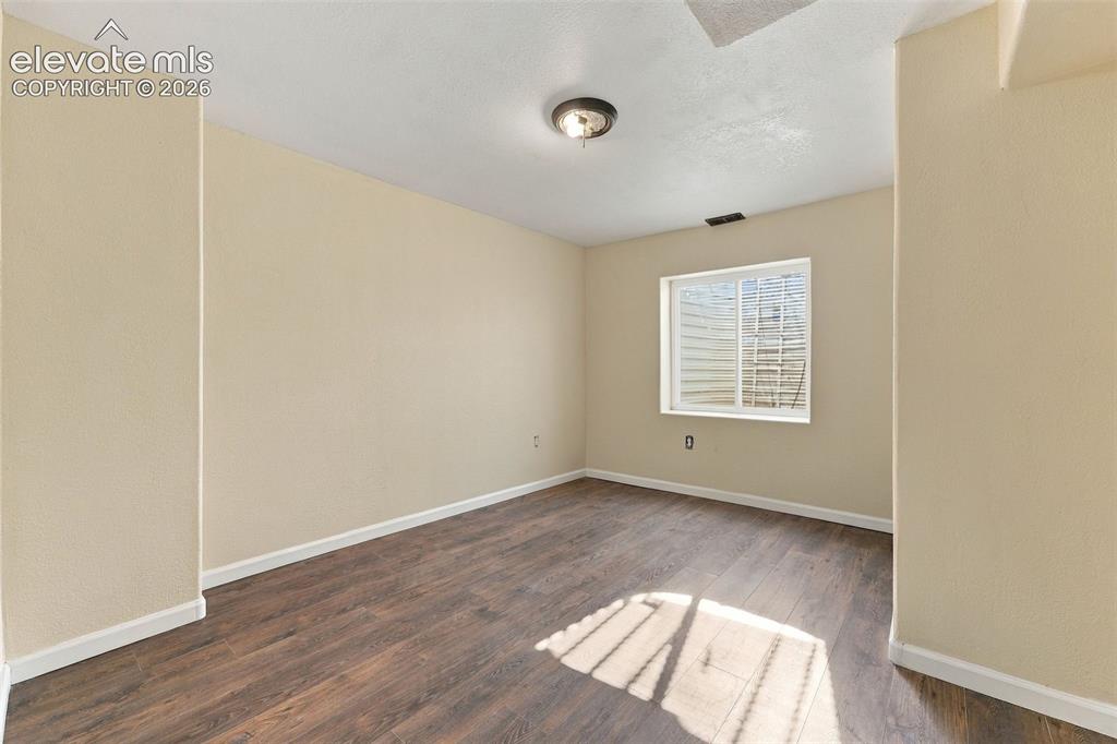 Image 30 of 50: Interior space featuring wood-finish flooring, neutral wall tones, a single