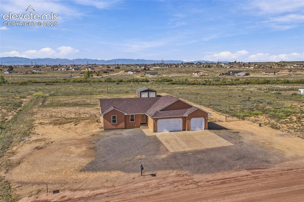 Image 37 of 50: Single-story residence featuring a composite shingle roof, stucco exterior,