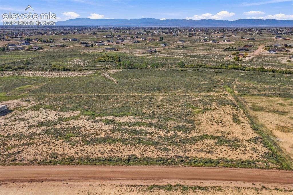 Image 39 of 50: Expansive, undeveloped acreage featuring prominent mountain range horizons