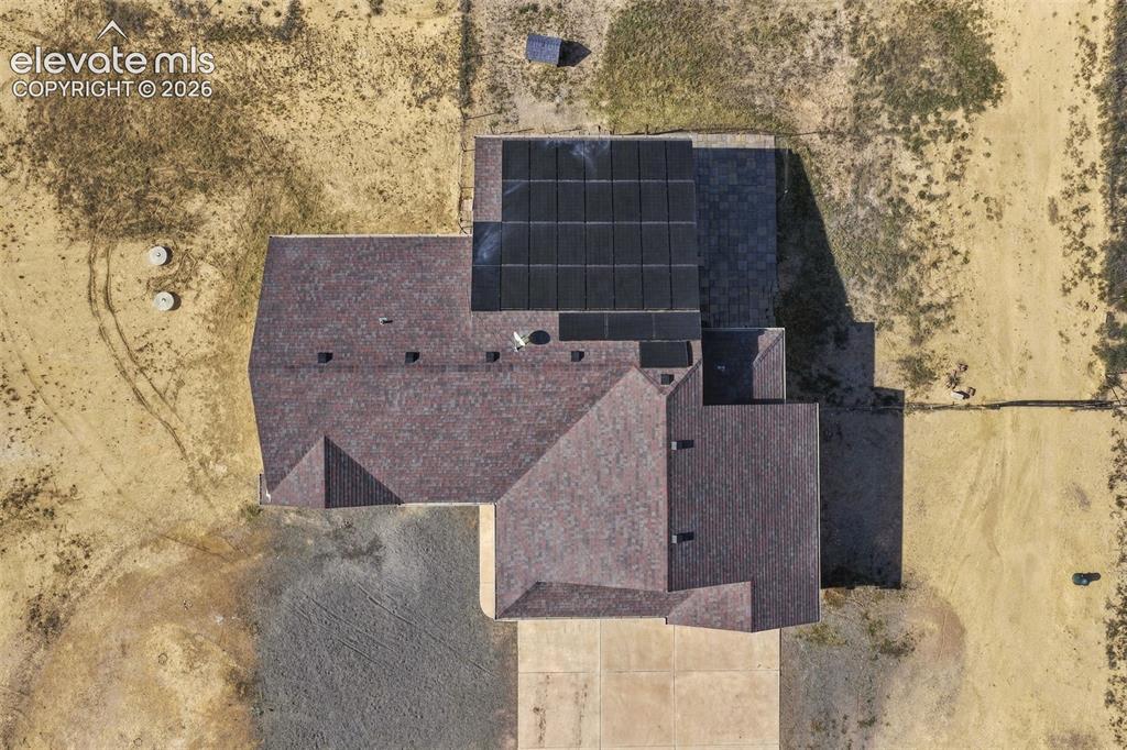 Image 45 of 50: Aerial perspective of the property featuring a composition shingle roof, in