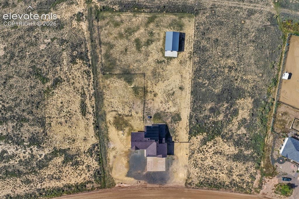 Image 46 of 50: Aerial perspective of a sprawling lot featuring a detached structure with a