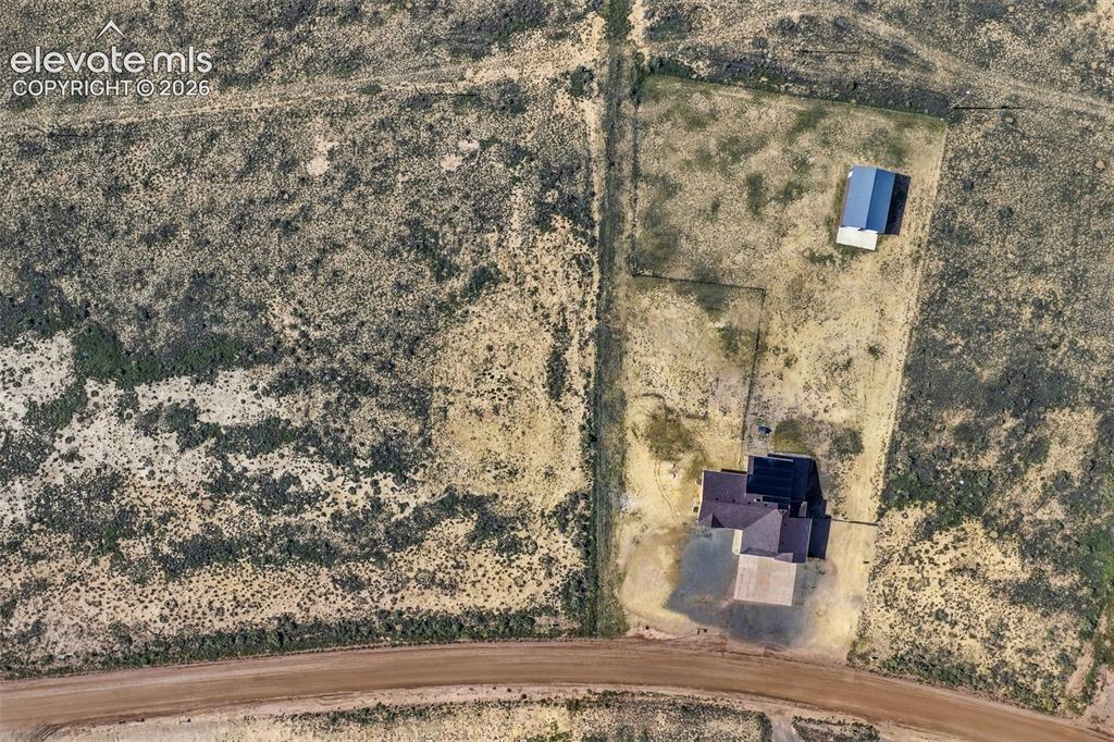 Image 47 of 50: Aerial perspective of a sprawling property featuring a primary residence wi