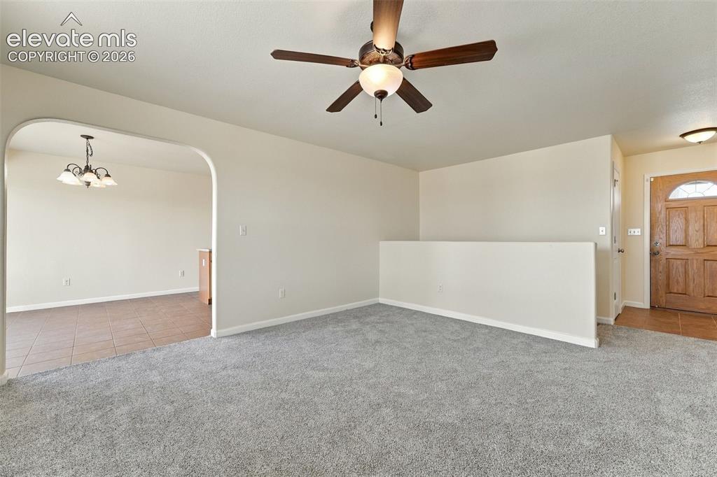 Image 5 of 50: Interior space featuring neutral wall-to-wall carpeting, an arched architec