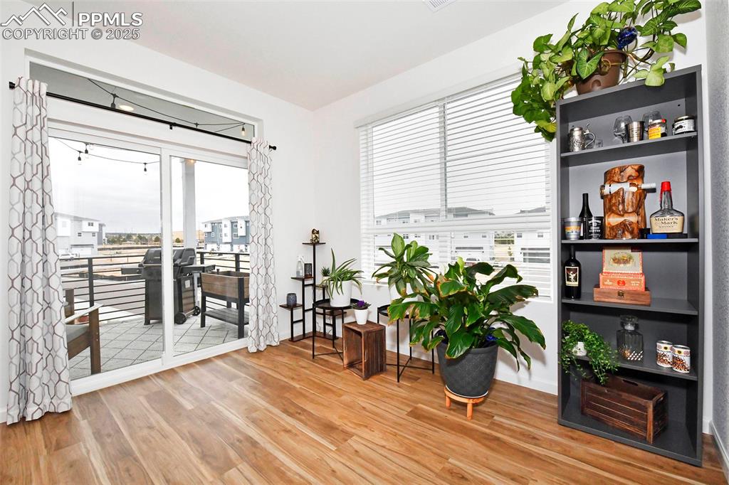 Image 13 of 26: Sitting room with light wood finished floors and baseboards