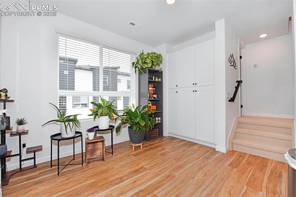 Image 15 of 26: Sitting room featuring light wood-style flooring, stairway, and recessed li