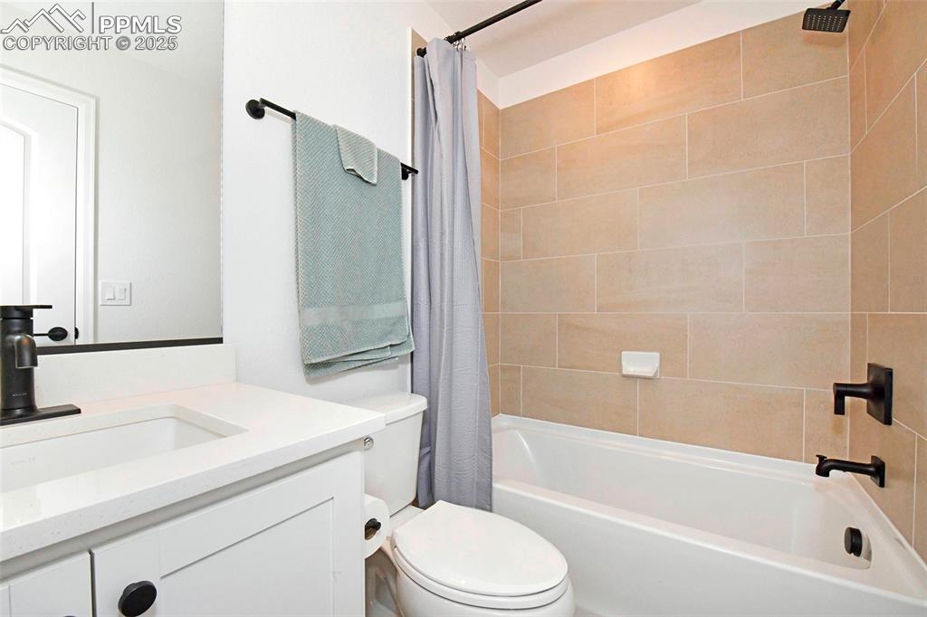 Image 22 of 26: Full bath featuring vanity and shower / tub combo