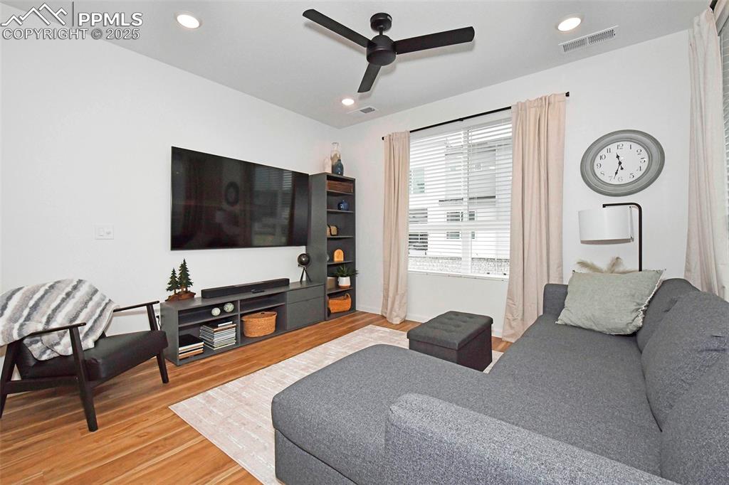 Image 7 of 26: Living room featuring light wood-type flooring, recessed lighting, and a ce