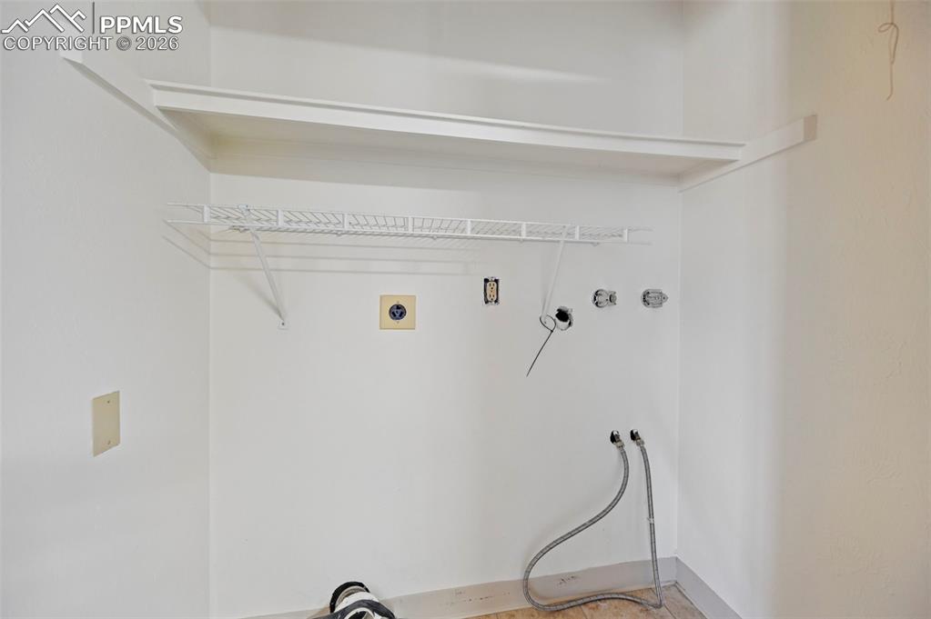 Image 22 of 42: Washer and Dryer hookups off kitchen