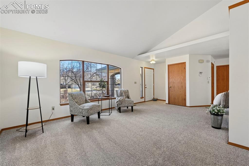 Image 4 of 42: Living room from front door with coat closet and large picture windows