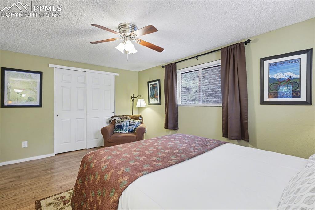 Image 21 of 33: Primary bedroom with hardwood flooring