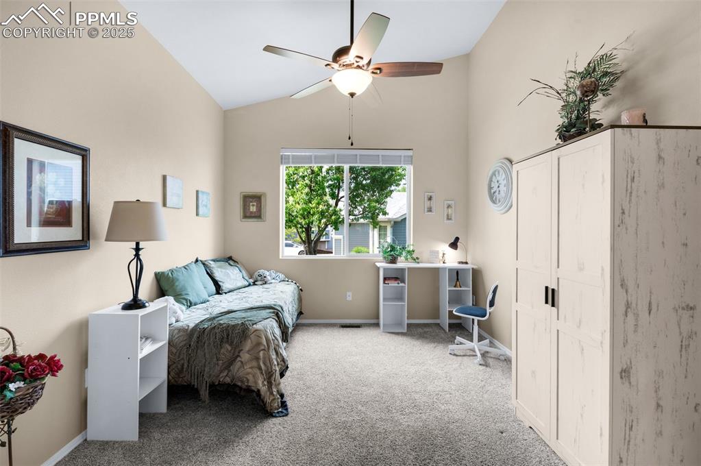 Image 25 of 50: Third Bedroom main level.   Ceiling fan, vaulted ceiling.