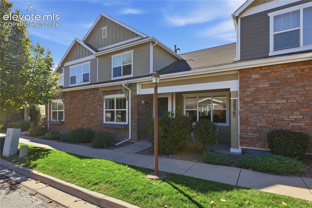 Image 1 of 28: Exterior featuring stone veneer and horizontal siding, gabled rooflines, mu