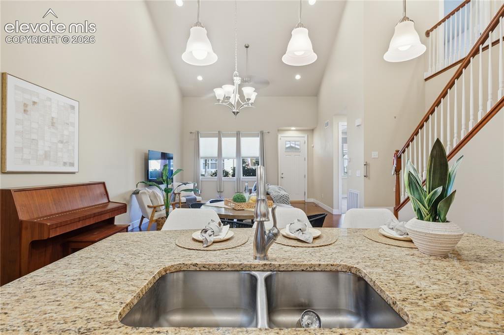 Image 10 of 28: Kitchen island with granite countertop and dual basin stainless steel sink