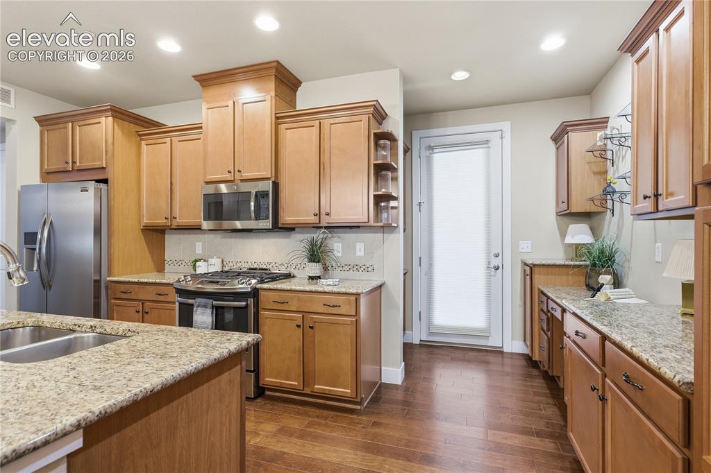 Image 11 of 28: Kitchen featuring wood-finish flooring, recessed lighting, and light wood c