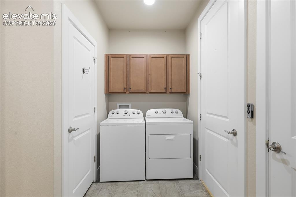 Image 12 of 28: Built-in wood-finish cabinetry, overhead lighting, and durable flooring