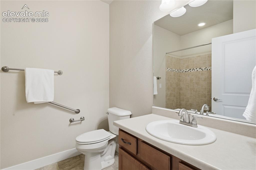 Image 23 of 28: Built-in vanity with a single basin sink and brushed nickel faucet, wood-fi