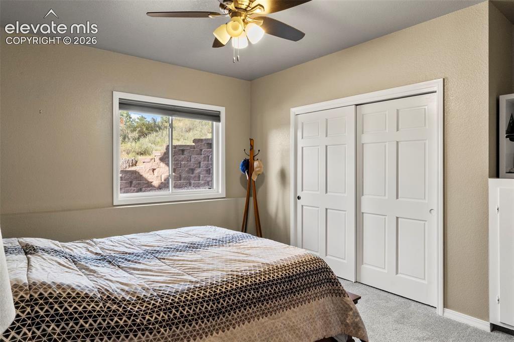 Image 31 of 46: Bedroom with carpet, a closet, and ceiling fan