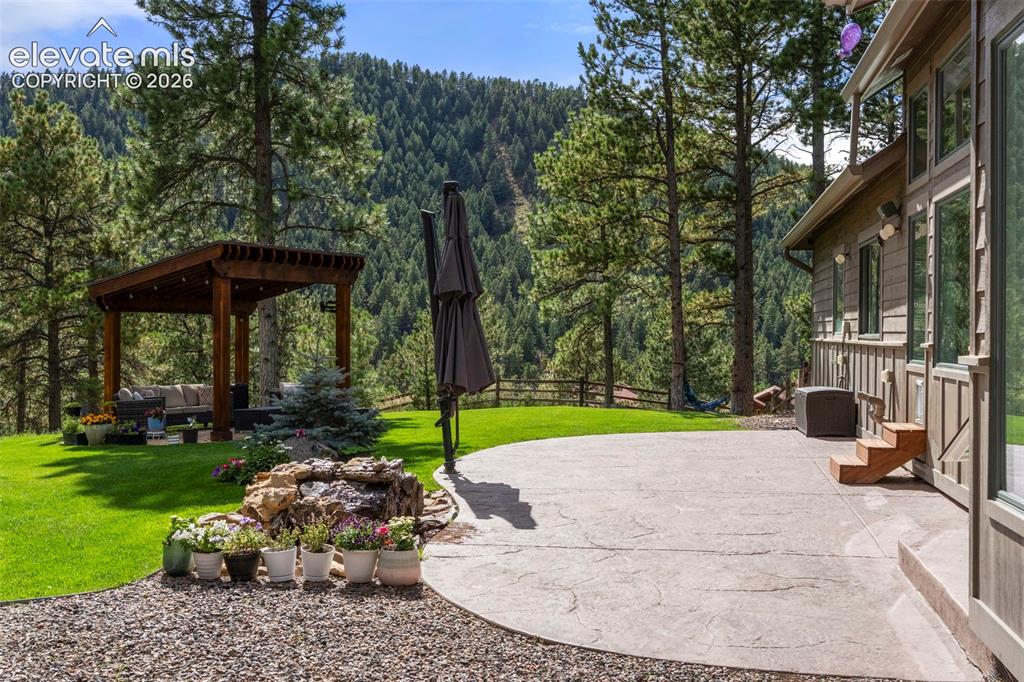 Image 33 of 46: View of patio / terrace with a view of trees