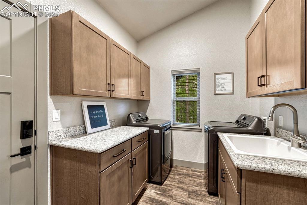 Image 15 of 32: Spacious laundry room with abundant storage, deep utility sink and extended