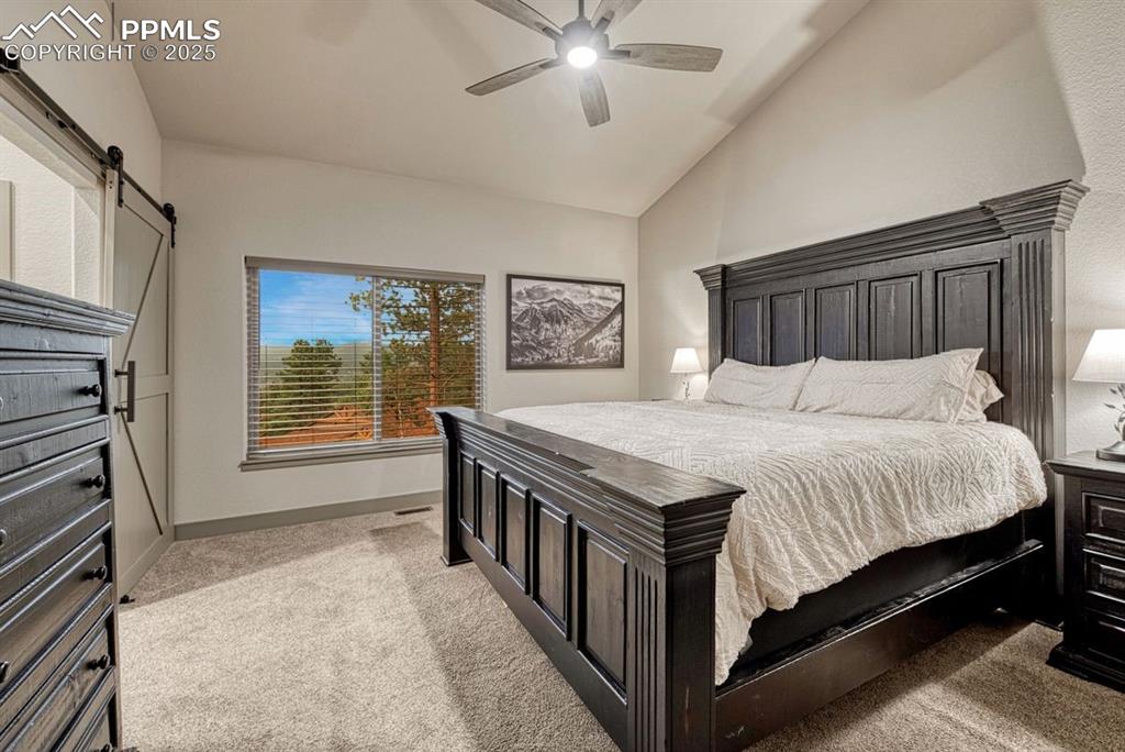 Image 16 of 32: Well-considered details like the low-profile barn door leading to the en-su