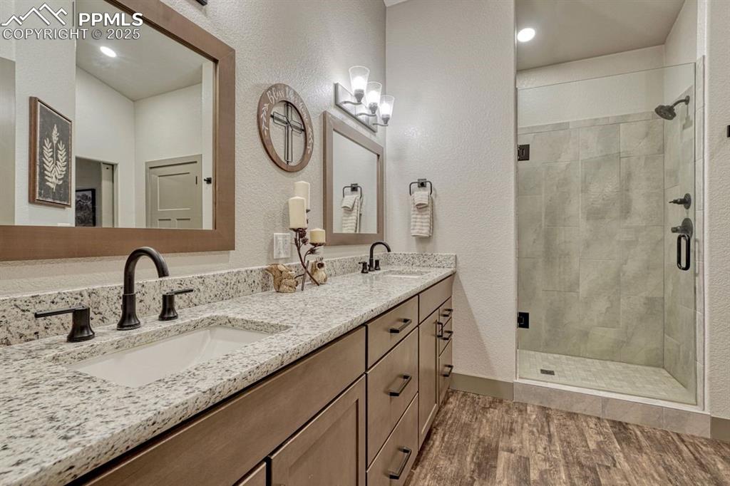 Image 18 of 32: The primary en-suite features a luxury walk-in shower with bench, toiletry 