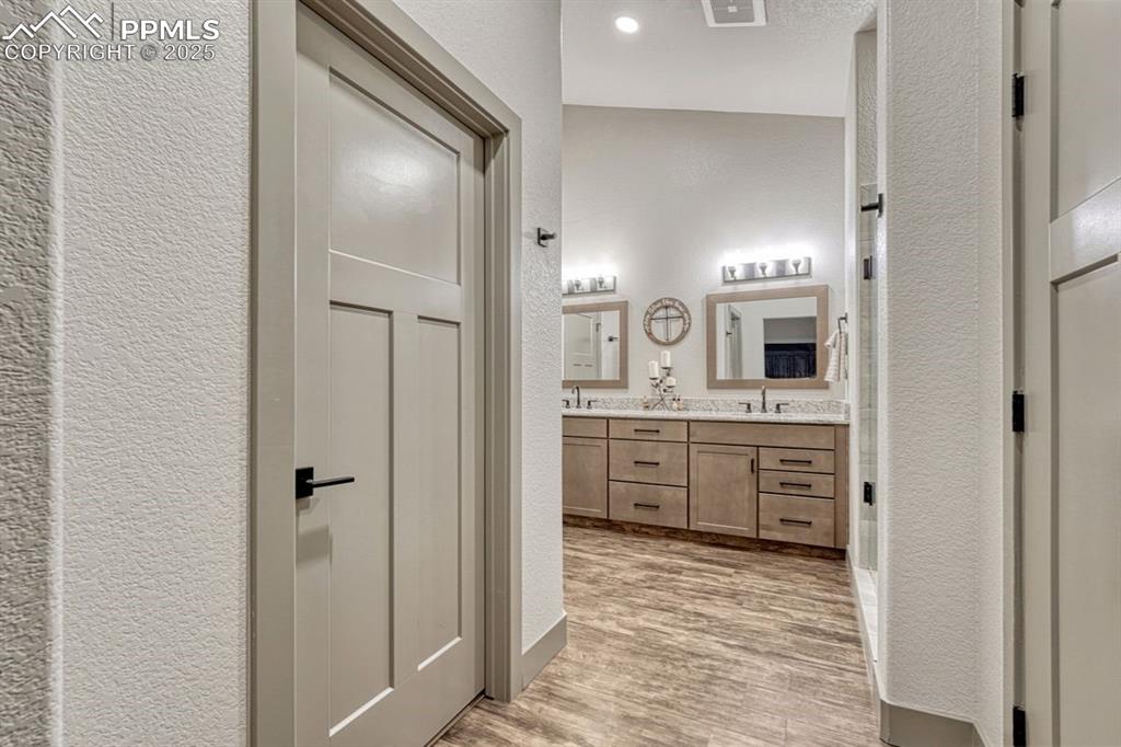 Image 19 of 32: Behind the Shaker style 3 panel doors, are the linen and walk-in closets