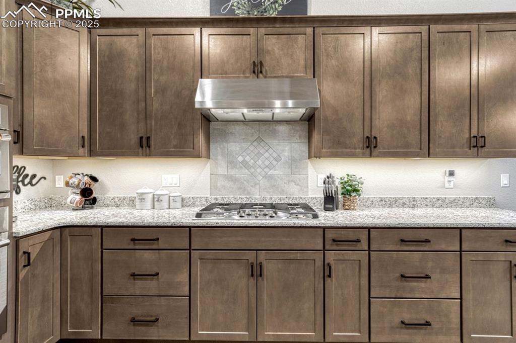 Image 3 of 32: The kitchen features high end GE Cafe appliances, gorgeous granite counters