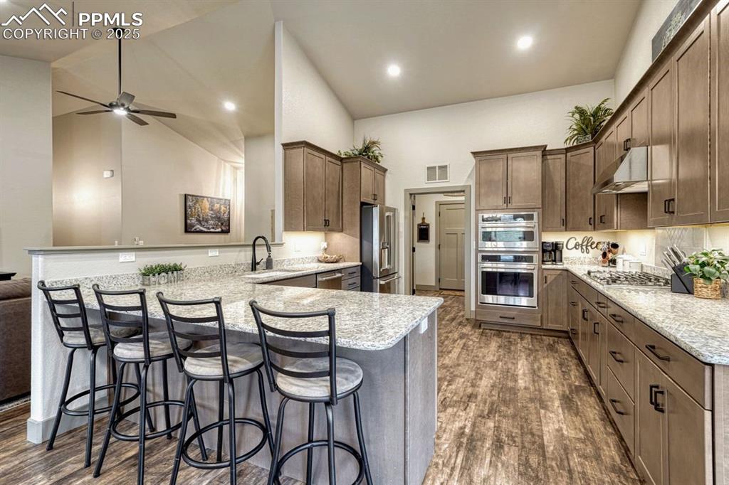 Image 4 of 32: Sleek granite breakfast bar - the perfect place to hang out while being out