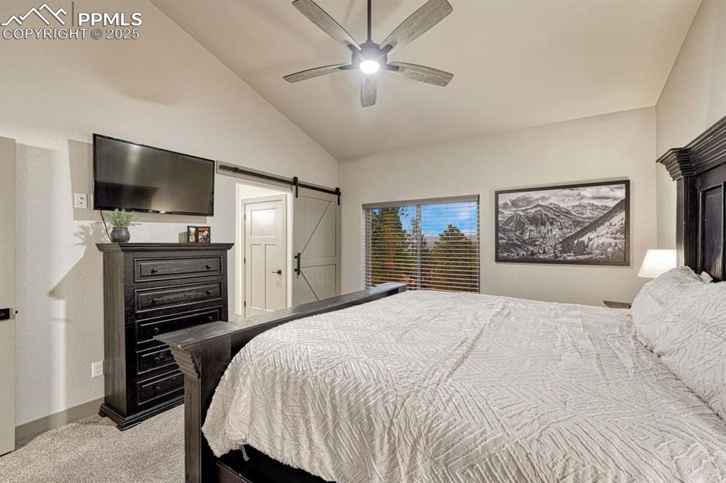 Image 5 of 32: Primary en-suite looks out over the pines and is spacious with a serene pal