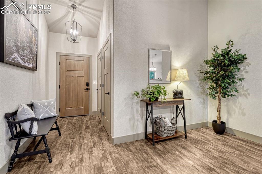 Image 8 of 32: Entry, great room and kitchen feature weathered barn wood LVP, not just bea