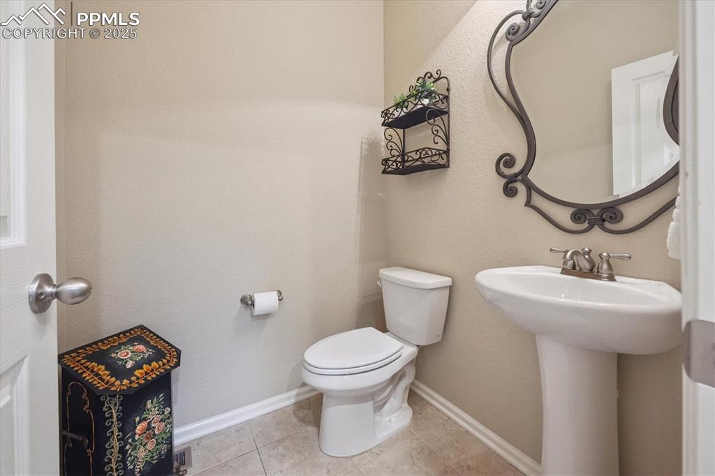 Image 14 of 36: Bathroom featuring a textured wall and tile patterned flooring