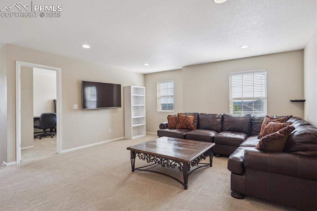Image 16 of 36: Carpeted loft featuring an office area, recessed lighting, and a textured c