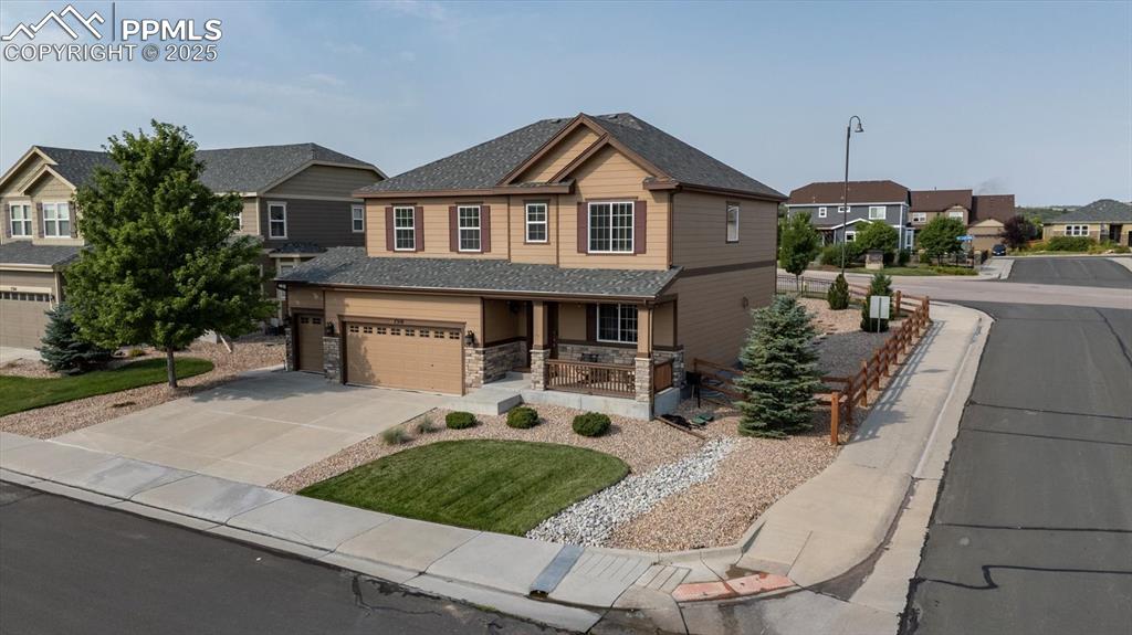 Image 2 of 36: Craftsman inspired home featuring a porch, a residential view, roof with sh