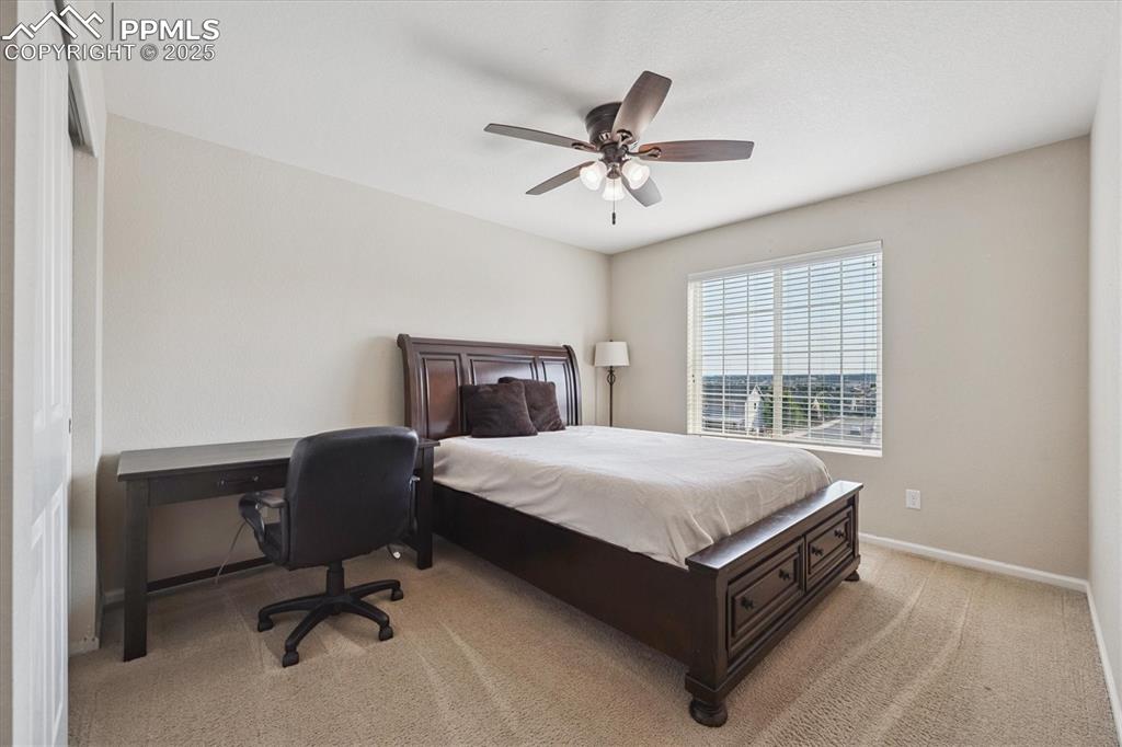 Image 21 of 36: Bedroom featuring light colored carpet and ceiling fan