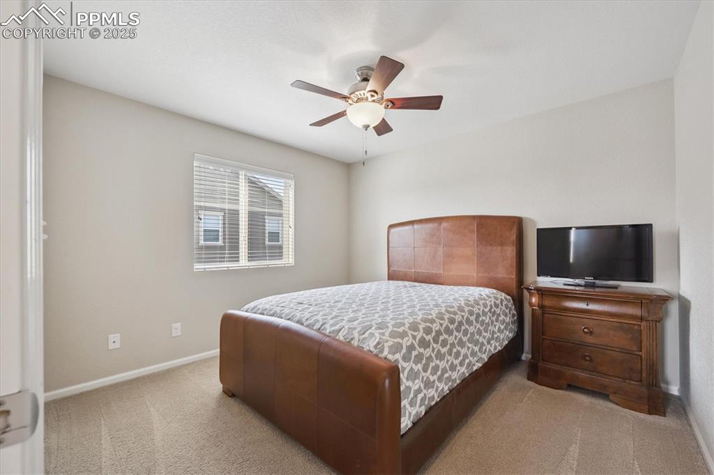 Image 23 of 36: Carpeted bedroom with baseboards and a ceiling fan
