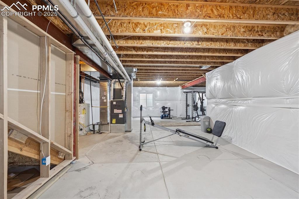 Image 27 of 36: Below grade area with water heater and heating unit
