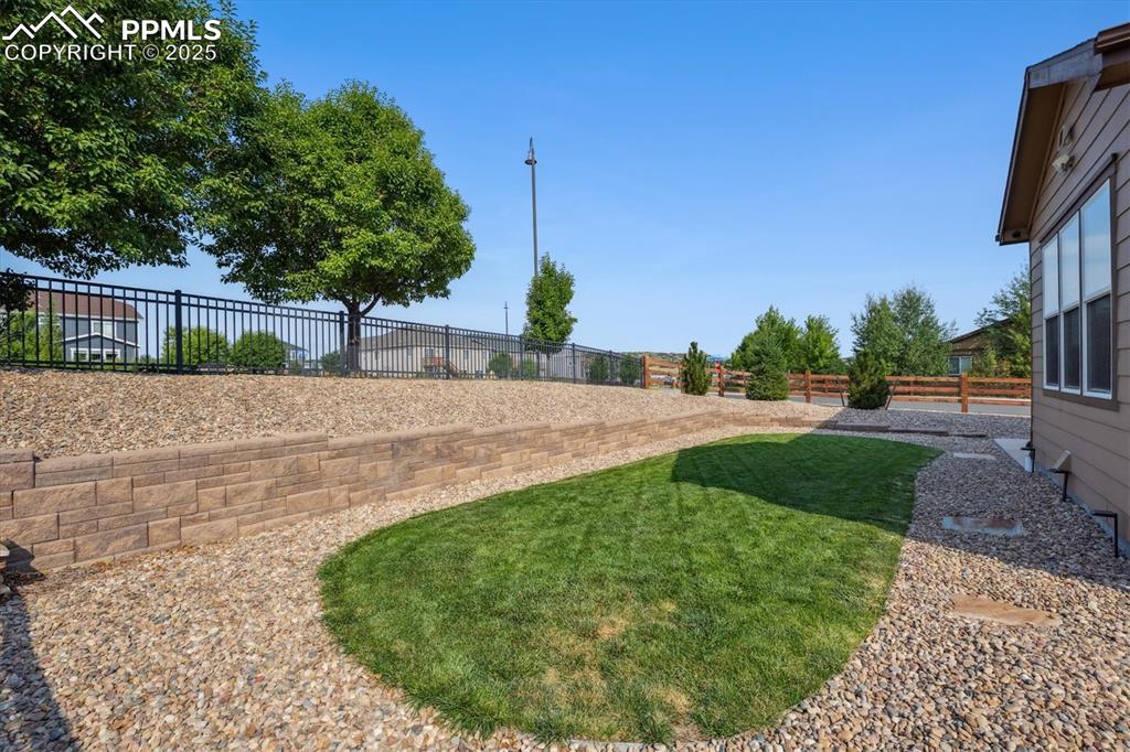 Image 31 of 36: View of fenced backyard