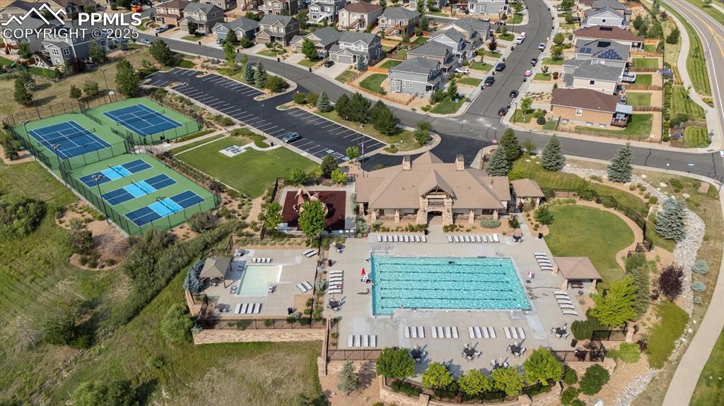 Image 35 of 36: Aerial perspective of suburban area with a pool area