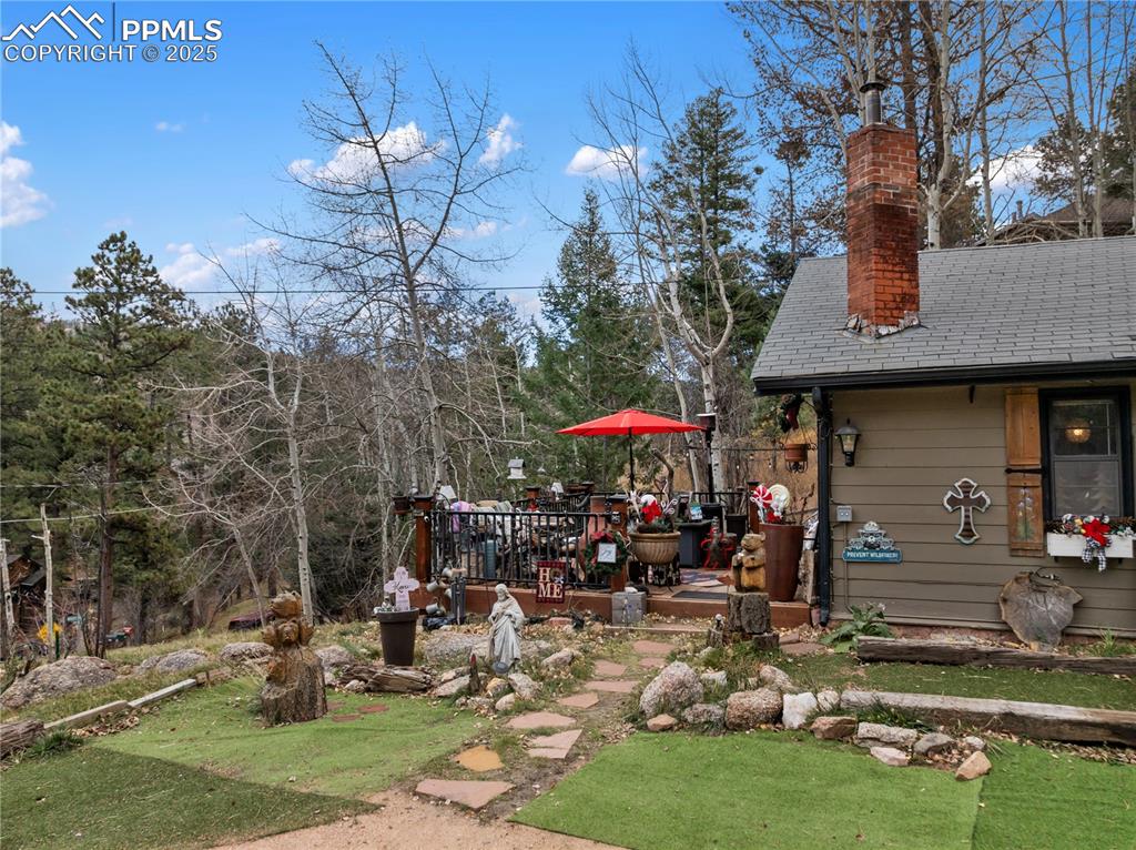 Image 12 of 47: View of the upper wooden deck and side of building