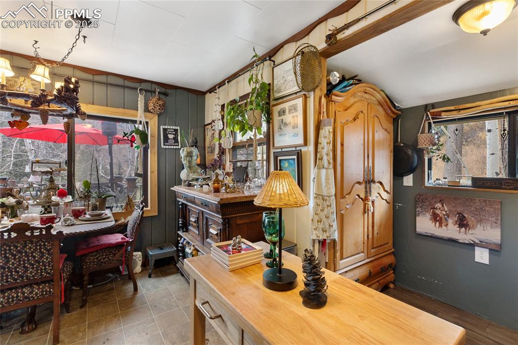 Image 23 of 47: Dining area with wood walls