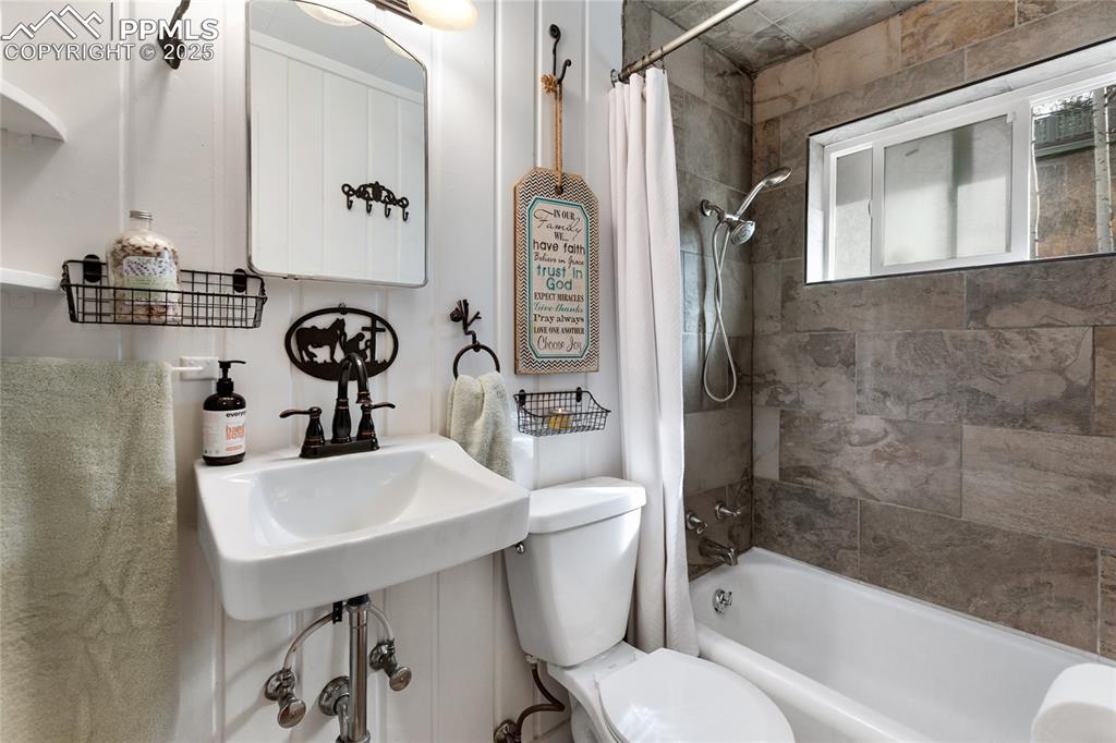 Image 31 of 47: Full bath featuring toilet and shower / tub combo with curtain