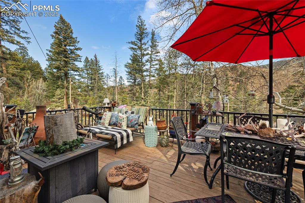 Image 4 of 47: Deck with outdoor dining area and an outdoor living space