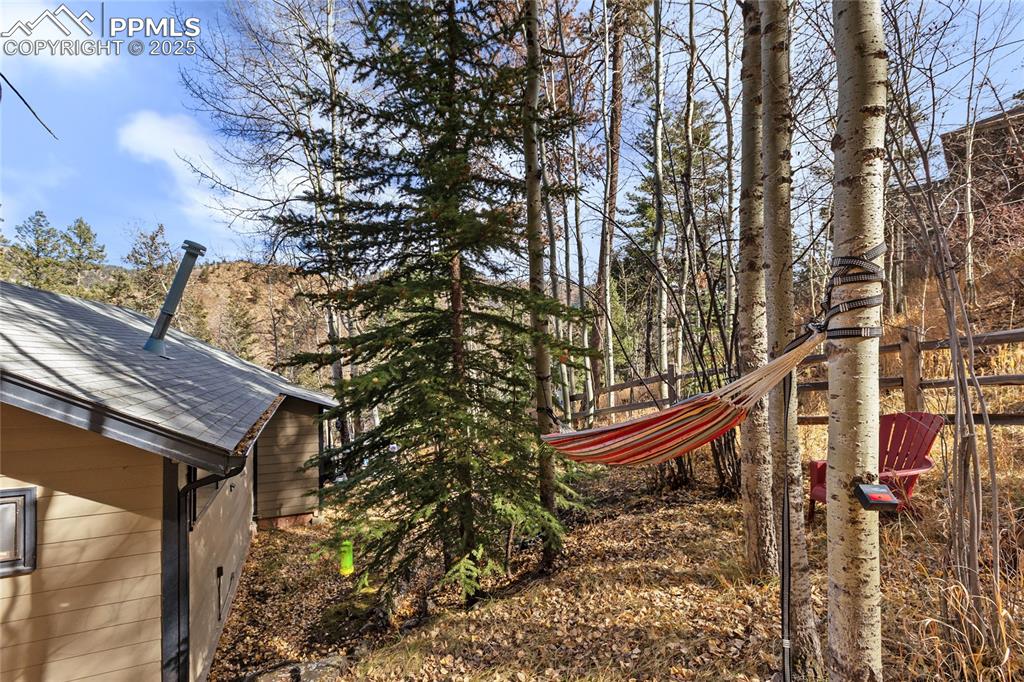 Image 8 of 47: View of yard, side of building and outdoor seating