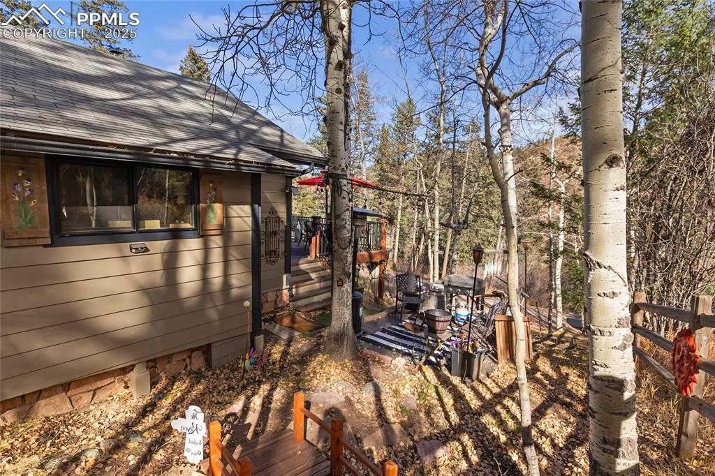 Image 9 of 47: View of yard featuring a wooden deck