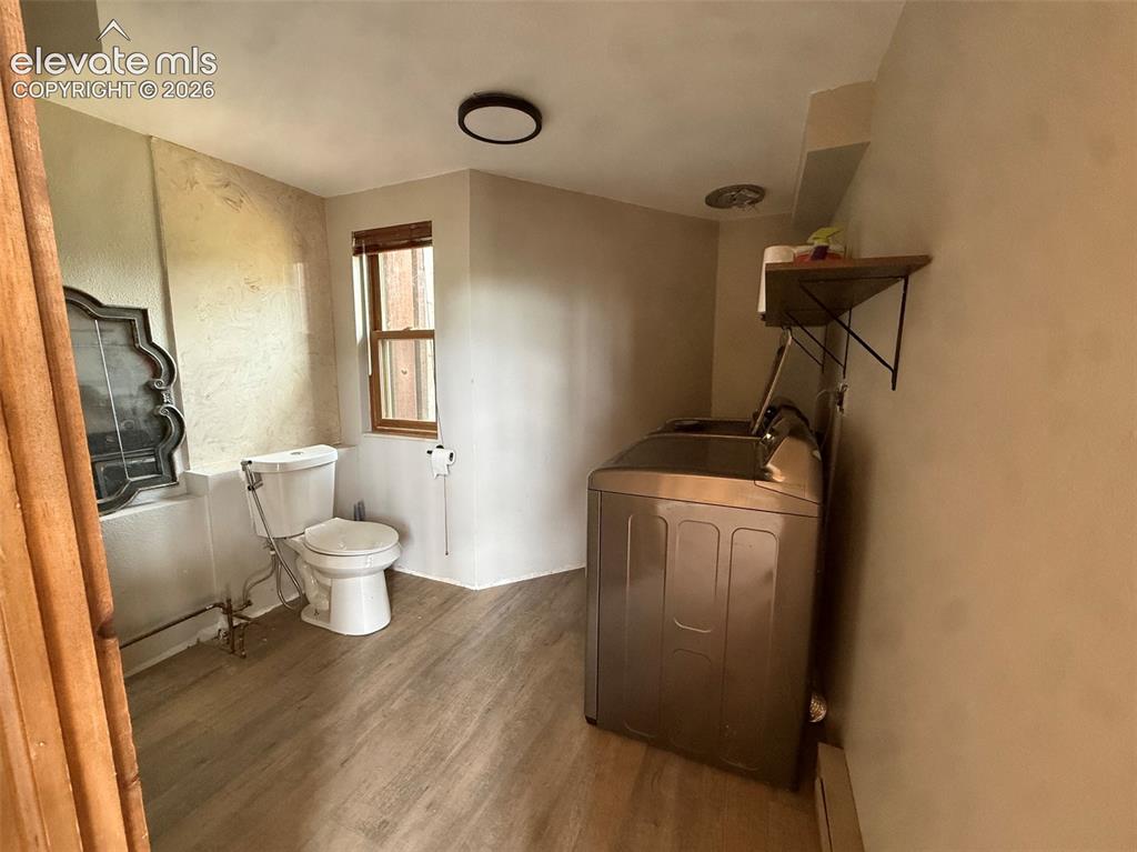 Image 16 of 33: Guest bath and laundry off family room