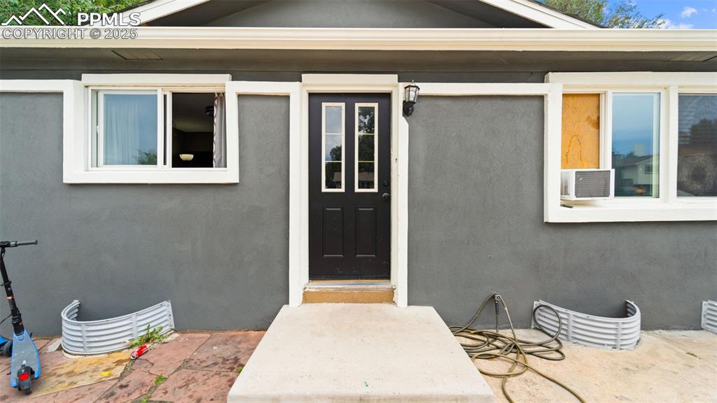 Image 4 of 21: Property entrance featuring stucco siding