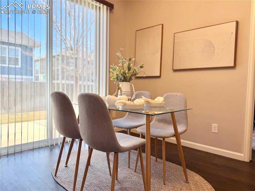 Image 12 of 41: Dining area featuring dark wood-type flooring